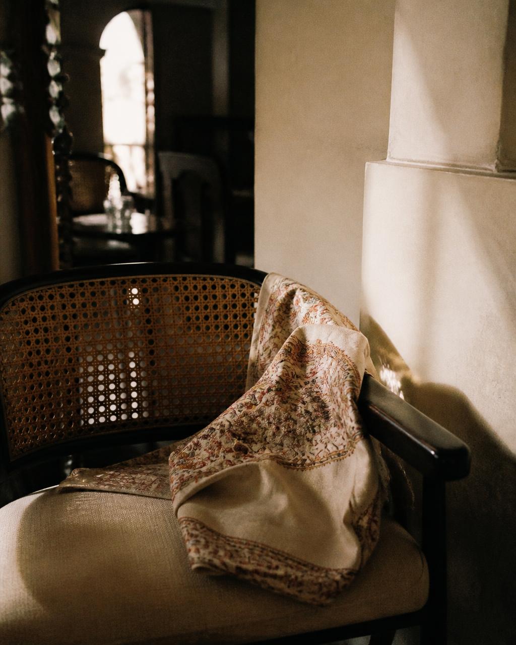 A cane chair and hand-printed textile inside Bia Species
