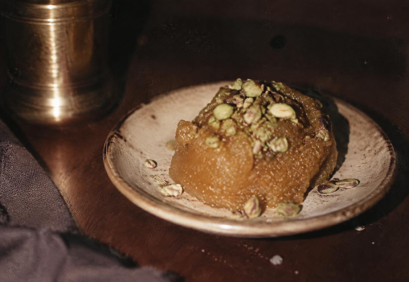 Pistachio halwa served on a small ceramic dish